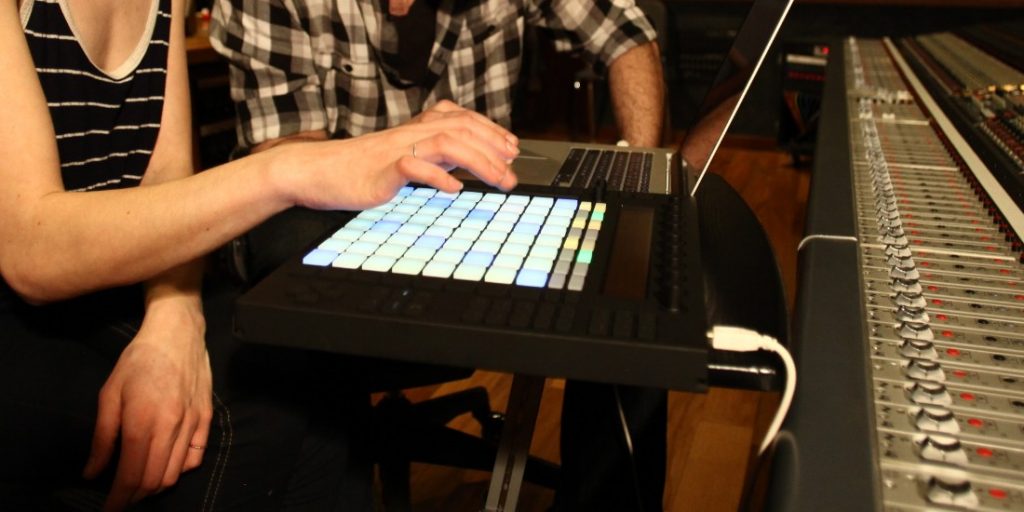 Two people working with Ableton Push