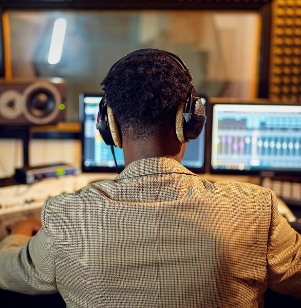 A sound effects editor with his back to the camera