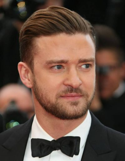 Justin Timberlake in a black tuxedo and bow tie at a red carpet event.