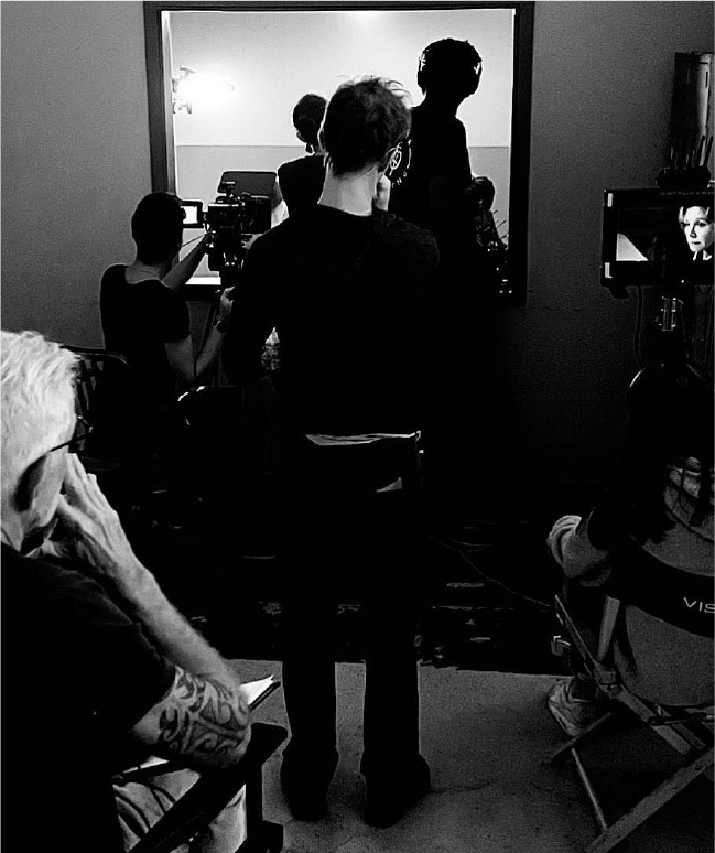 Black and white image of people on a set.