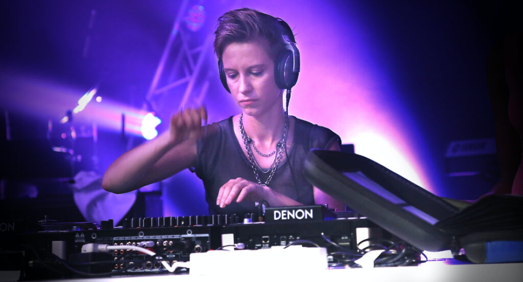 Image of a woman djing in a club to illustrate How to Get DJ Gigs in New York
