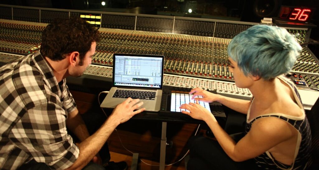 A student and mentor in a recording studio to illustrate How to Learn About Music in New York.