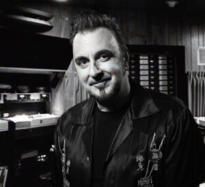 A black and white photo of Tim Palmer in the studio. He will be a panelist for Recording Connection at the 2023 NAMM Show.