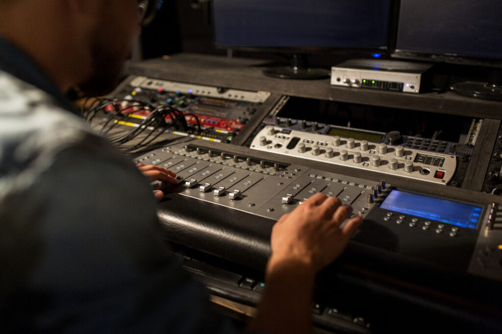 Image of someone at a control board to illustrate What Music Production Studios are in Dallas